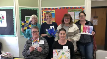 South Shore Medical Center Colleagues holding artwork